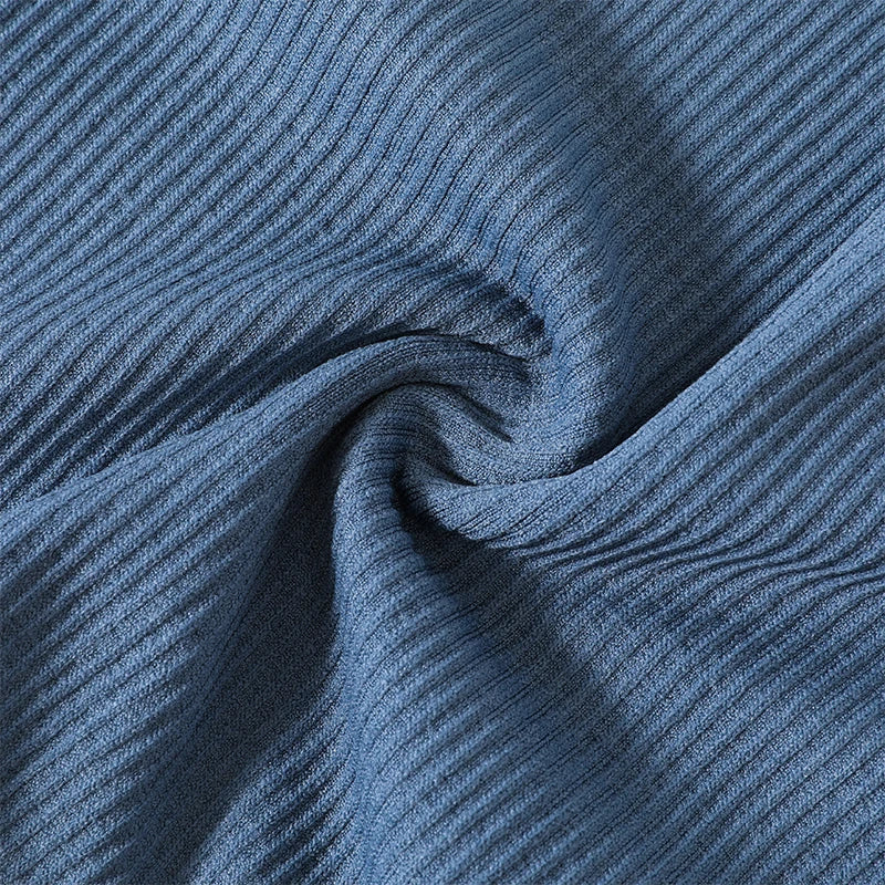 Close-up of textured blue nylon fabric showcasing seamless design for women's streetwear crop top.