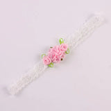 Delicate white lace headband with pink rose flowers and green ribbons for baby girls.