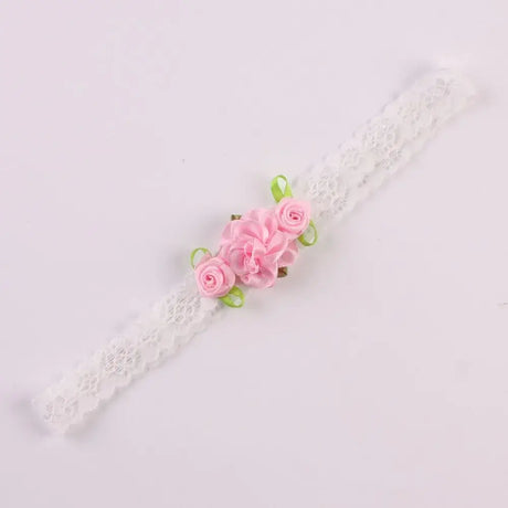 Delicate white lace headband with pink rose flowers and green ribbons for baby girls.