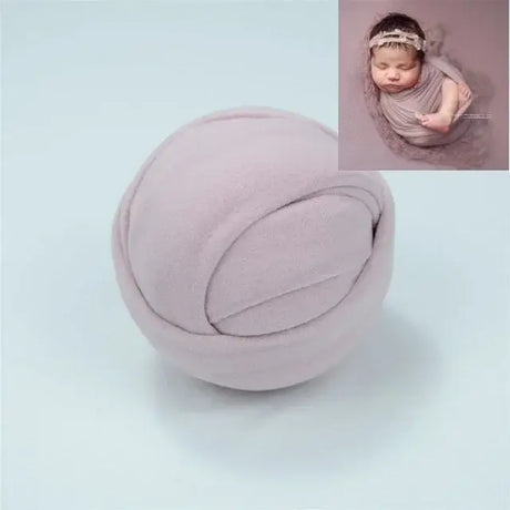 Soft pink blanket perfect for baby photo shoots, providing a cozy backdrop for newborn photography.
