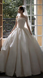 Elegant bridal gown with a strapless bodice and voluminous skirt, showcasing satin fabric and a timeless design.