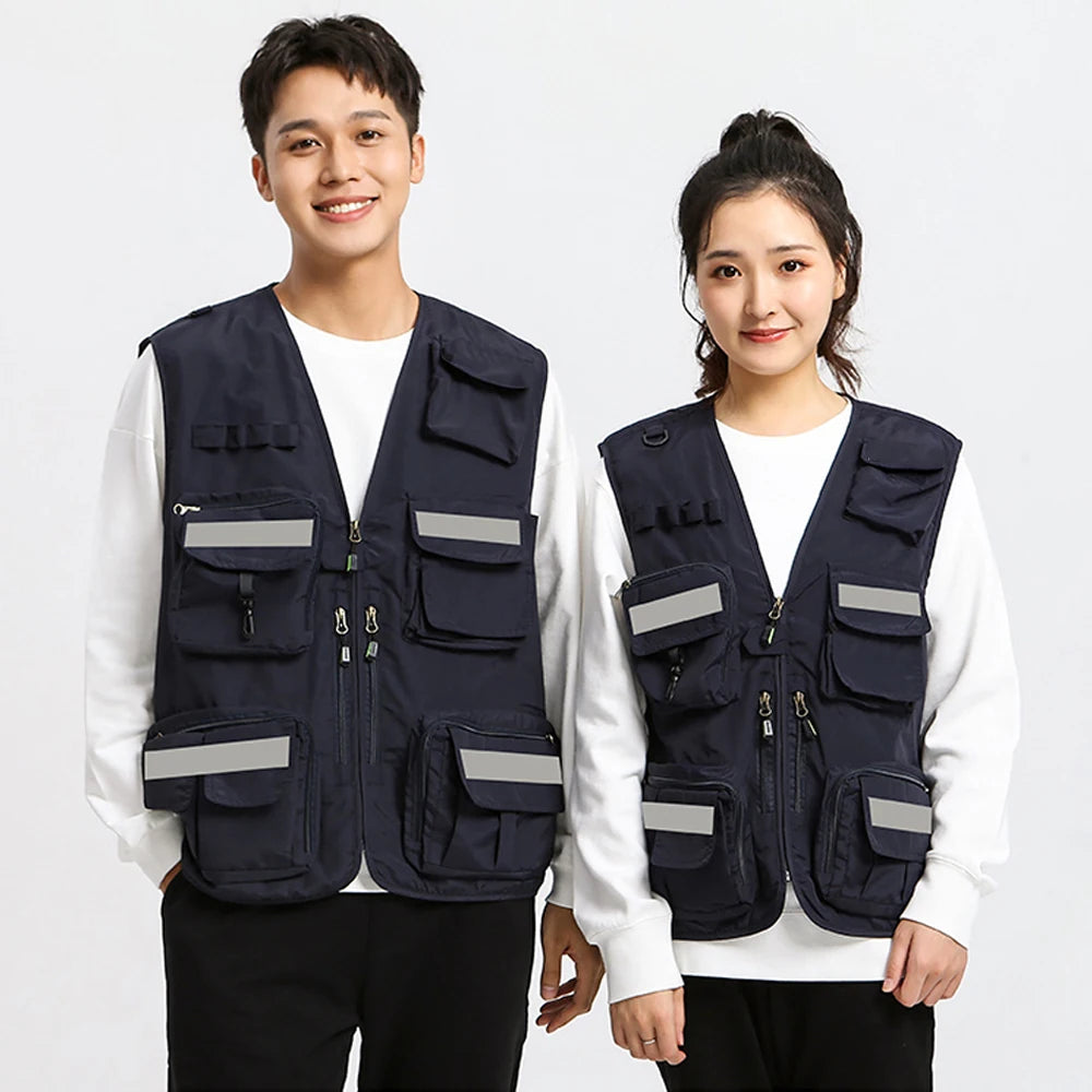 Two individuals wearing navy blue utility vests with multiple pockets and reflective strips, suitable for work and outdoor activities.