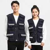 Two individuals wearing navy blue utility vests with multiple pockets and reflective strips, suitable for work and outdoor activities.