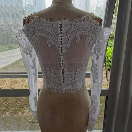 Lace Off Shoulder Bridal Jacket with intricate appliqued design and long sleeves from Noble Weiss