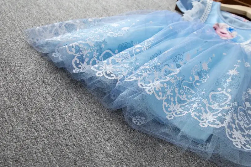 Girls summer flying sleeve dress in blue, adorned with intricate white lace patterns, perfect for casual wear.