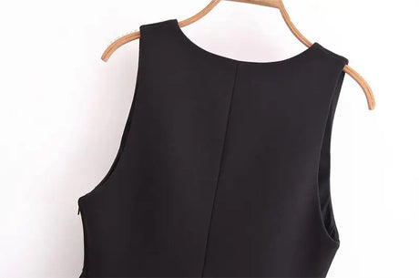 Back view of an elegant black women tank top showcasing its simple design and regular length.