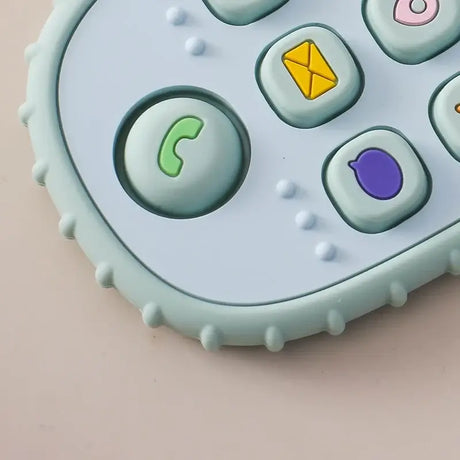 Close-up of a soft silicone baby teether glove with colorful buttons, designed for infant tooth pain relief.