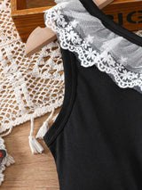 Close-up of toddler girl dress with black fabric and lace detail on the shoulder, perfect for summer wear.