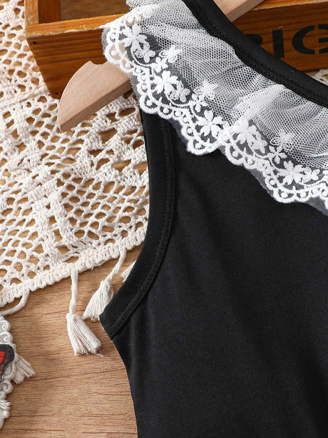 Close-up of toddler girl dress with black fabric and lace detail on the shoulder, perfect for summer wear.