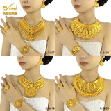 Luxury Indian bridal jewelry set featuring necklaces, earrings, rings, and bracelets in 24K gold finish.
