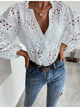 Model wearing LaceWhisper™ white lace shirt with V-neck, paired with jeans and a stylish belt.