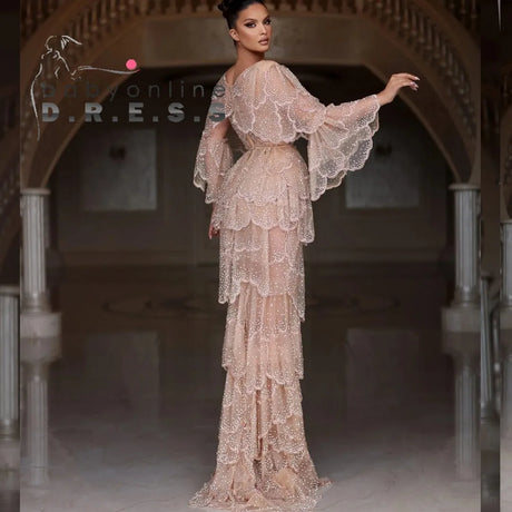Elegant Arabic nude stone wedding gown with tiered sleeves in beige, featuring beaded embellishments and a sweetheart neckline.