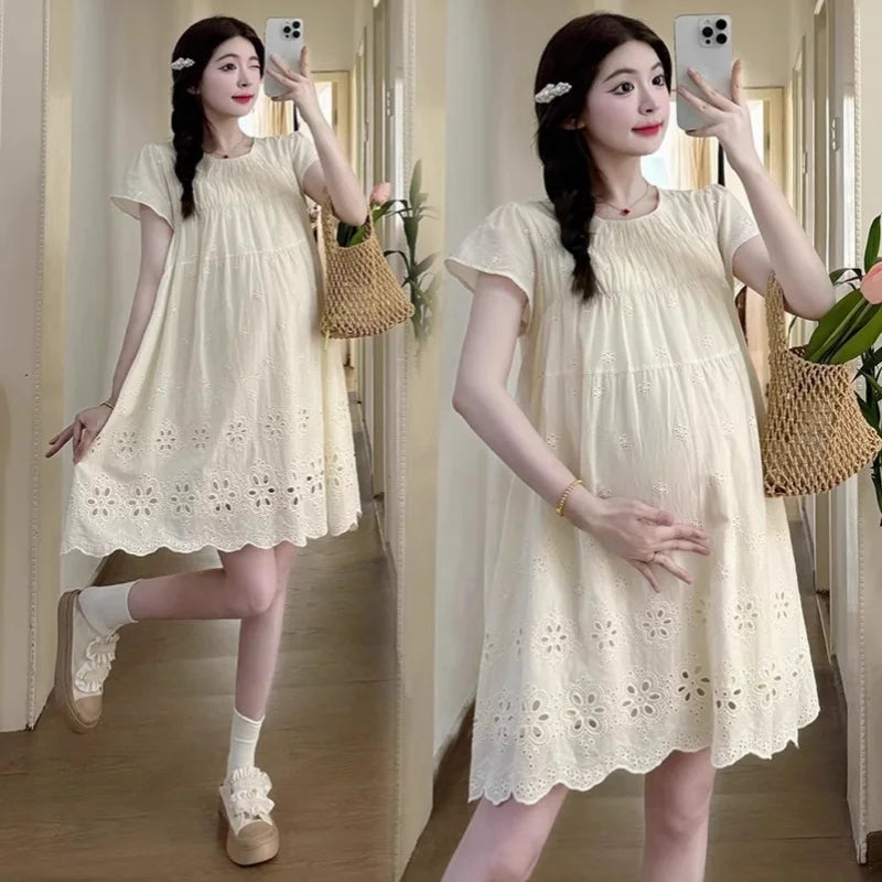 A-line cotton maternity dress in natural color, featuring a hollowed out style and knee-length cut, ideal for summer.