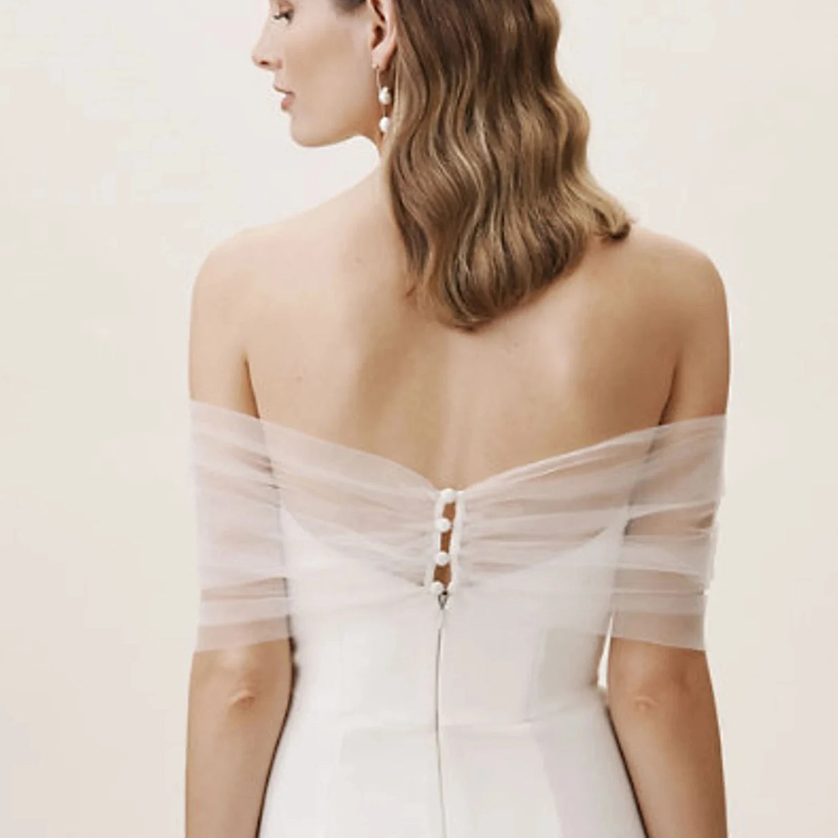 Back view of a bride wearing a VG73 sheer wedding jacket with delicate see-through sleeves.