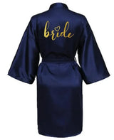 Navy satin robe for brides with gold 'bride' lettering, perfect for wedding day preparations.