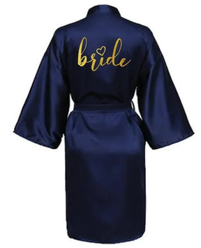 Navy satin robe for brides with gold 'bride' lettering, perfect for wedding day preparations.