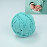 Turquoise blanket backdrop for baby photography, featuring soft material for comfortable and cute photo shoots.