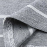 Close-up of gray striped fabric showing soft texture and stitching details for a nursing dress.