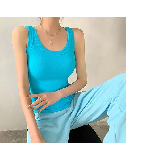 Woman wearing a bright blue ribbed tank top paired with matching pants, showcasing a stylish streetwear look.