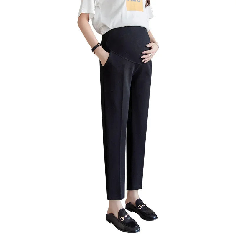 Formal black maternity pants for women, featuring a comfortable fit and pockets, ideal for summer work wear.