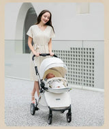 Mom pushing a twin baby stroller with a soft-colored canopy, ideal for infants and toddlers, on a stylish outdoor pathway.