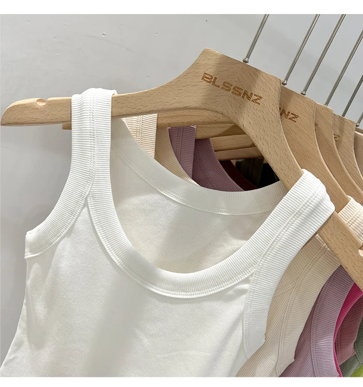 RibFlex™ Basic O-Neck Tank in white, cotton, ribbed texture, displayed on wooden hangers.