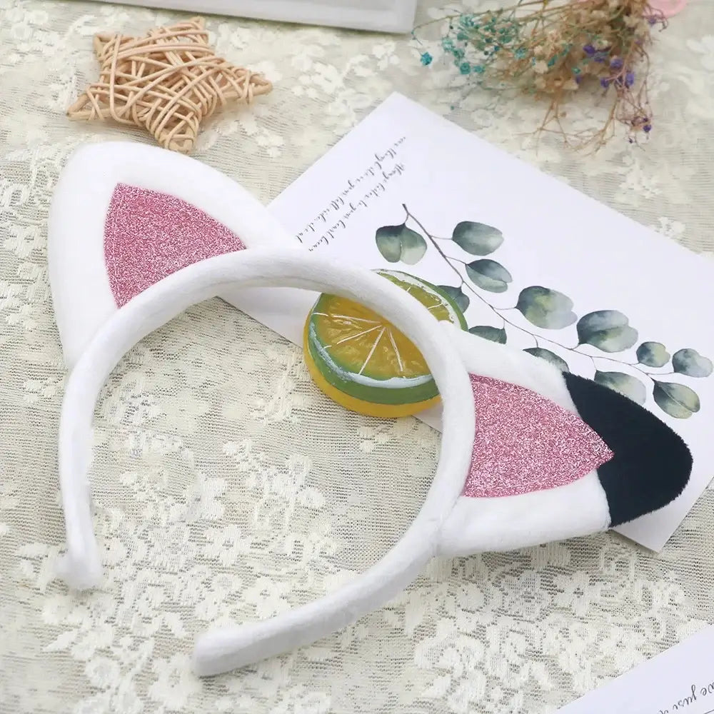 Cute cat ear headband with pink glitter decoration, perfect for children's costumes and parties.