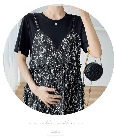 Elegant black floral maternity dress with spaghetti straps, perfect for baby showers and summer outings.