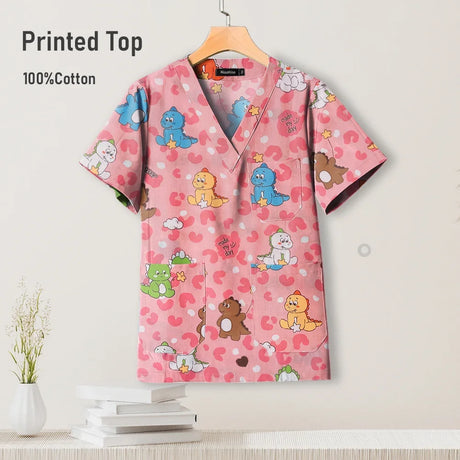 Pediatric nursing uniform scrub top in pink cotton with colorful cartoon animals, perfect for hospitals and beauty salons.
