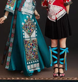 Miao embroidery suit for women featuring vibrant designs, a long skirt, and a festive festival costume look.