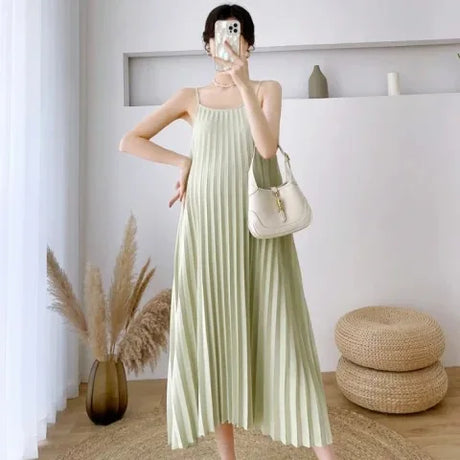 Pleated chiffon maternity dress in soft green, mid-calf length, perfect for summer, showcasing a stylish silhouette.