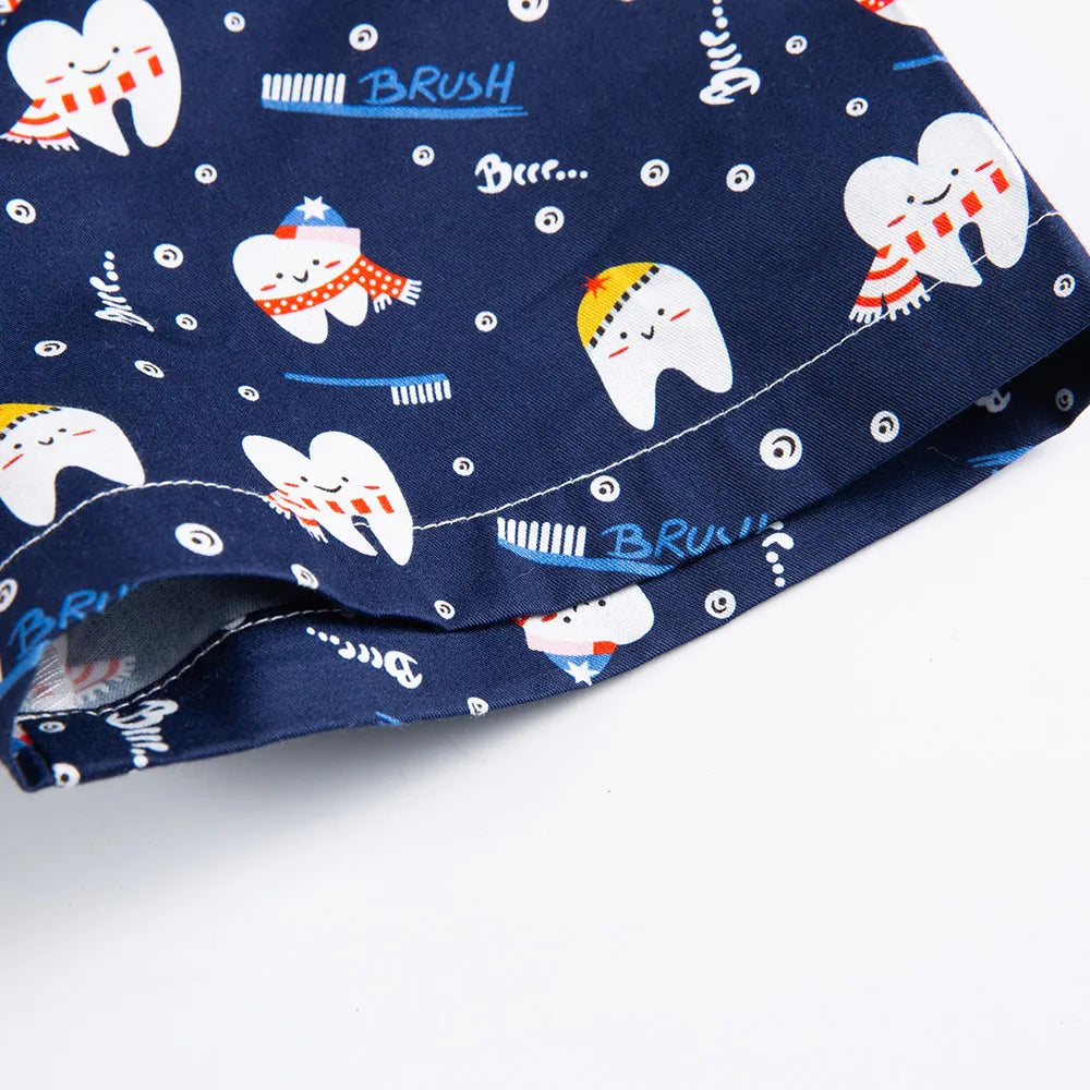 Navy blue cotton nurse scrubs with fun tooth and brush print, ideal for medical or dental professionals, ensuring comfort and style.