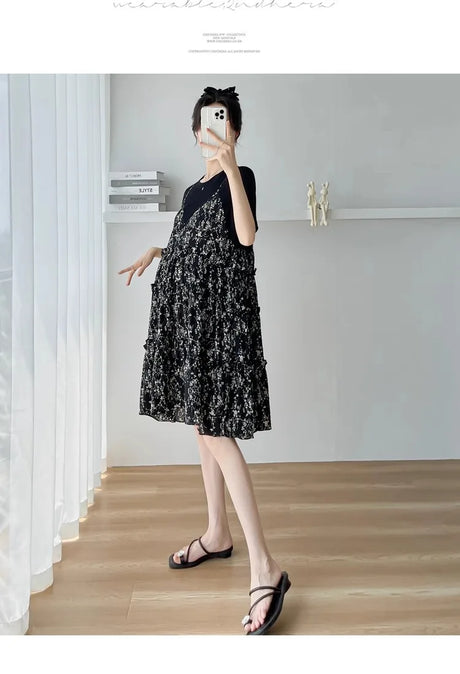 Black floral maternity dress with ruffles, perfect for summer baby showers, featuring knee-length design and boat neck.