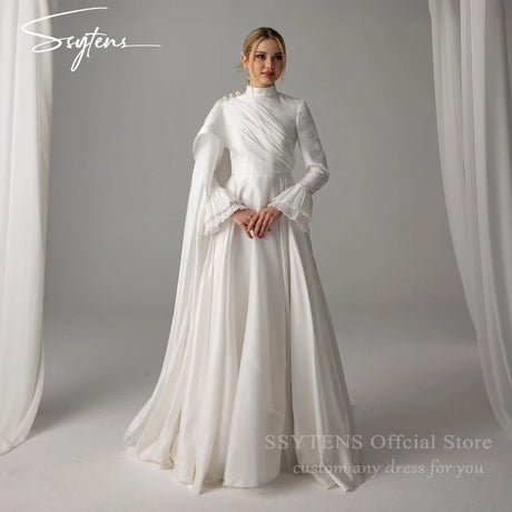 Muslim satin wedding dress with high neck, long sleeves, and pearl embellishments, showcasing a floor-length design.