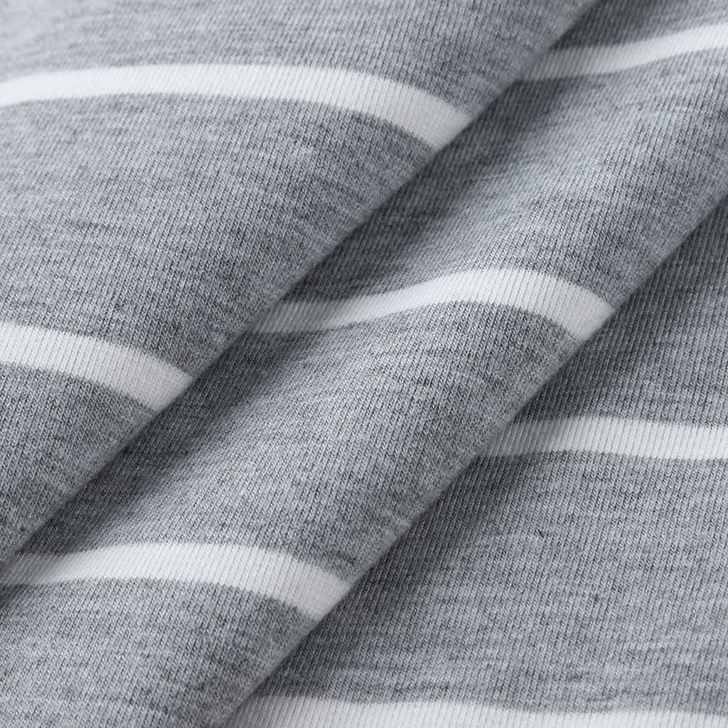 Close-up of grey striped fabric featuring soft textures and white lines, ideal for a multifunctional dress.