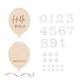 Wooden baby flower shape milestone set with balloons, numbers, and floral decor for capturing memories.