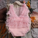 Newborn photography prop in pink, featuring ruffled design and lace detailing, perfect for baby photoshoots.