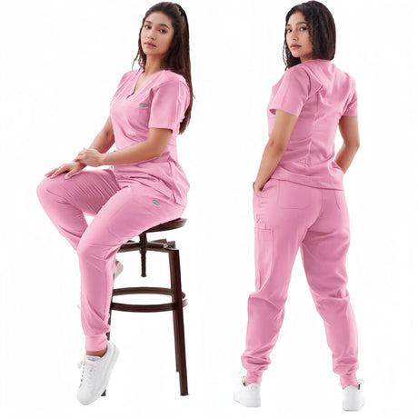 Women in pink breathable medical scrub set, showcasing short sleeve top and pants, ideal for healthcare professionals.