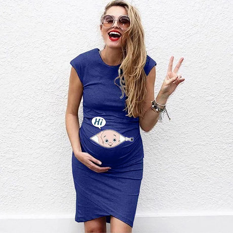 Smiling pregnant woman in casual blue dress with cartoon graphic, showcasing a playful maternity style.