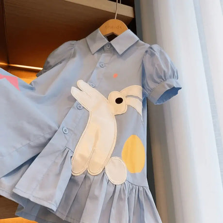 Girls knee-length blue dress with rabbit and circle design, perfect for summer fashion.
