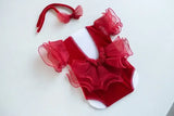 Newborn photography prop in red with ruffled sleeves and matching headband, perfect for unisex baby photos.