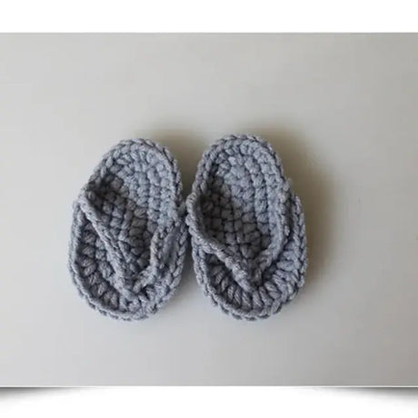 Cozy gray hand-crocheted baby slippers, designed for comfort and style, perfect for infants and toddlers.