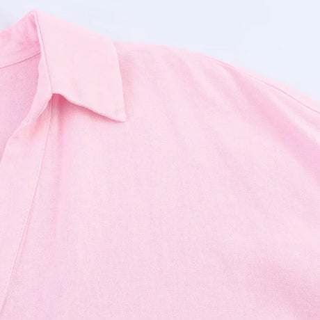 Close-up of pink turn-down collar fabric of a loose fit oversized shirt for women.