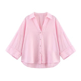 Pink oversized button-up shirt with wide sleeves and a relaxed fit for casual summer wear.