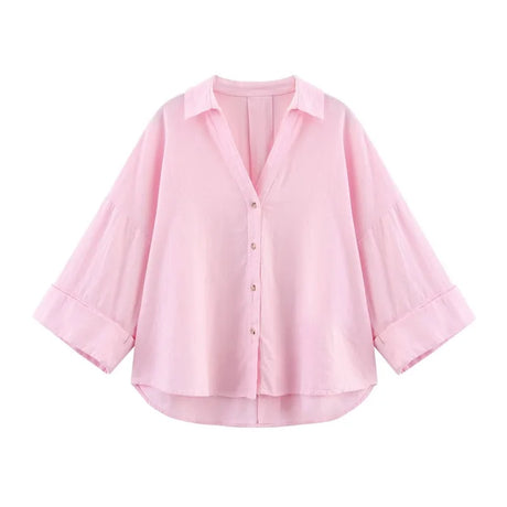 Pink oversized button-up shirt with wide sleeves and a relaxed fit for casual summer wear.