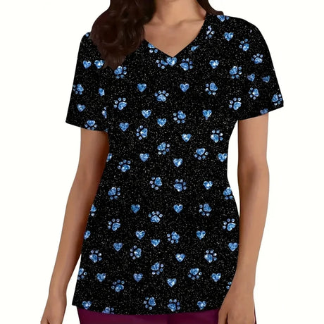 Cartoon cat print vet scrubs featuring blue hearts and paw prints on a black background, short sleeve nurse uniform for women.