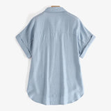 Light blue oversized summer blouse with rolled sleeves and turn-down collar, perfect for a relaxed fit.