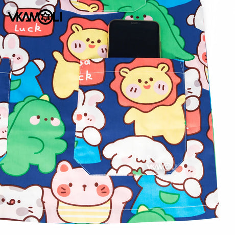 Colorful cartoon scrub top with pockets featuring playful animal designs and a smartphone, perfect for medical professionals.