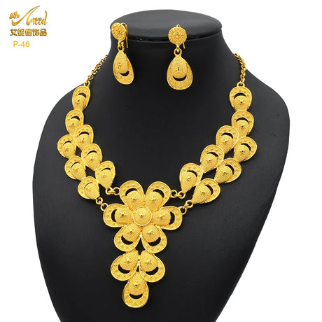 Luxury 24K gold plated Indian bridal jewelry necklace set with matching earrings, perfect for weddings.