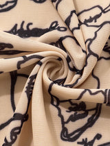 Close-up of lightweight printed fabric with a swirl pattern in beige and black, showcasing the texture and design.